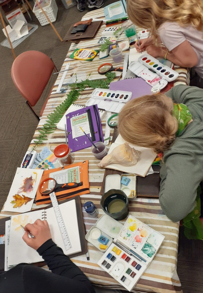 A family natural journaling together at Kelli Hertzler's class at Shenandoah National Park Trust's Art in the Park.
